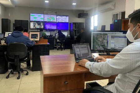 People sitting behind desks with computers.