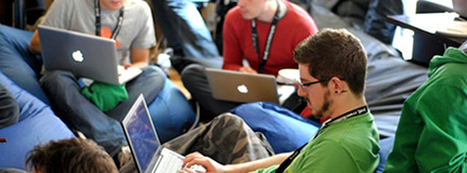 People on tech event sitting and working on laptops