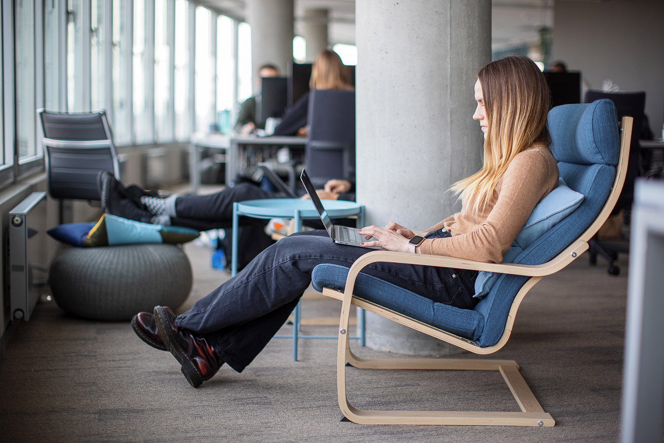 a woman sitting in the armchair with laptop