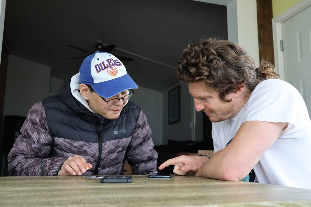 two people looking at the mobile screen 